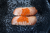 Appetizing fish sushi garnished with caviar