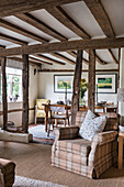 Rustic living room with wooden beams and watercolours on the wall