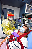 Patient and Paramedic in Protective Gear