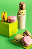 Verschiedene bunte Macarons vor grünem Hintergrund