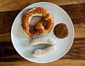 White sausages with sweet mustard and a pretzel