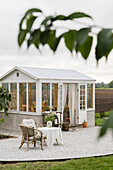 Seating area on terrace outside greenhouse