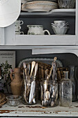 Vintage cupboard with cutlery in glasses