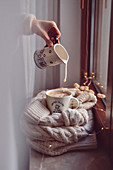 Woman pours milk into a cup of coffee Autumn climate