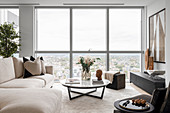 Modern living room in muted colors with a view of the city