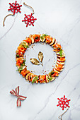 Festive apple carpaccio wreath with smoked salmon