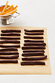 Chocolate covered orange sticks in a row