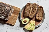 Fresh sliced wholegrain bread served with avocado and cheese for healthy nutrient breakfast