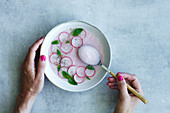 Refreshing radish cream soup with fresh basil leaves
