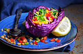 Purple cabbage leaf filled with mix of peppers and lentils