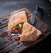 Calzone with porcini mushrooms, olives, sun-dried tomatoes and scamorza