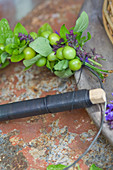 Wreath with green cherries: tie unripe cherries, salvia flowers and oregano alternately onto a wire ring