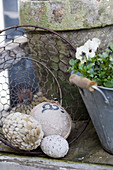 Eggs covered with various materials in wire basket