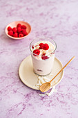 Coconut smoothie with raspberries in a glass