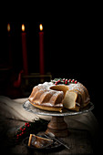 Bundt cake sprinkled with sugar powder and decorated with cranberries