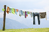 Laundry hung on washing line against blue sky and mountain panorama