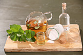 Lemon balm gel in jars, ingredients and utensils