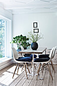 Classic chairs around dining table with wrought iron frame and oak top