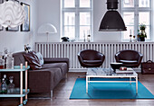 Sofa, retro armchair and coffee table with marble top in living room