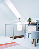 Railing made of zinc pipes in bright attic room