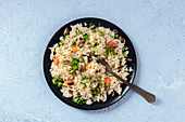 Vegan rice with carrot, broccoli and green peas