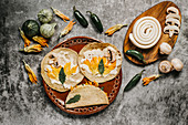 Tortillas with melted cheese and squash flowers near mushrooms and green chili peppers