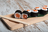 Set of Japanese hosomaki sushi rolls with fresh salmon fillet
