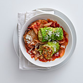 Vegetarian savoy cabbage roulade in tomato sauce with grilled bread