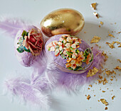 Easter eggs decorated with flower pictures and gold paper (decoupage technique)