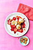 Vegan coconut rice pudding balls with berry sauce and nuts