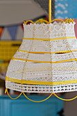 Lampshade made from yarn, lace trim and yellow and white ribbons