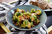 Brussels sprouts fried with bacon and nuts