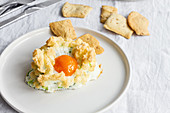 Cloud eggs with green vegetables and crackers for breakfast