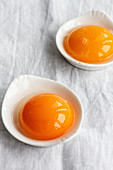 Making cloud eggs; egg yolks in small bowls