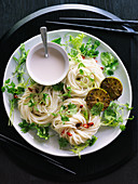 Rice noodles with coconut milk, herbs and grilled limes