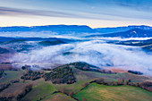 Fog over farmland, aerial view