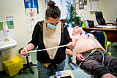 Man in consultation with a GP wearing a surgery mask