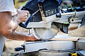 Worker using electric saw