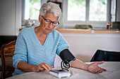 Woman taking her blood pressure