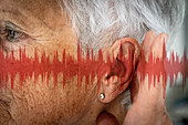 Ear of a woman with sound waves