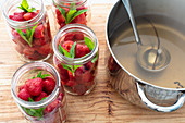 Fresh strawberries in jars with mint, ready for syrup