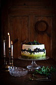 Blueberry cake with cream and mint on a cake stand