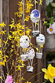 Hot-air balloons made from Easter eggs hung from forsythia branches