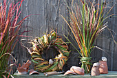 Grass decoration: wreath and bouquet of mixed grasses, clay pots, and snail shells as decoration