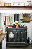 Antique kitchen oven in the alcove with an exhaust fan and nostalgic decor