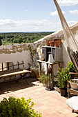 Mediterranean roof terrace with different objects and view over the countryside