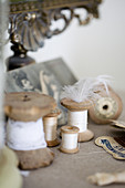 Thread spools and nostalgic objects in beige and white