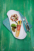 Carne cruda (tartare) with celery, Parmesan and asparagus wrapped in ham