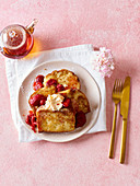 French toast breakfast casserole with poached strawberries and powdered sugar