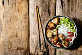 Grilled deep fried pork belly in bowl with rice, celery, chili pepper and spring onion